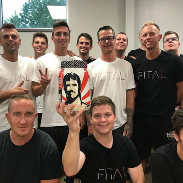 Group of people with one person holding a Vintage Brawn bottle