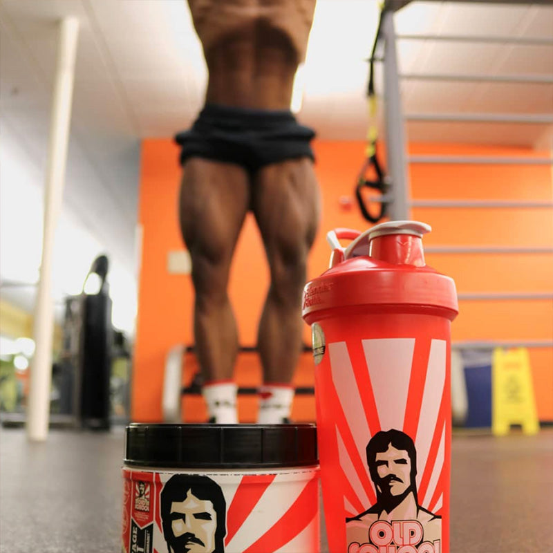 Man posing at the gym with bottle of Vintage Blast