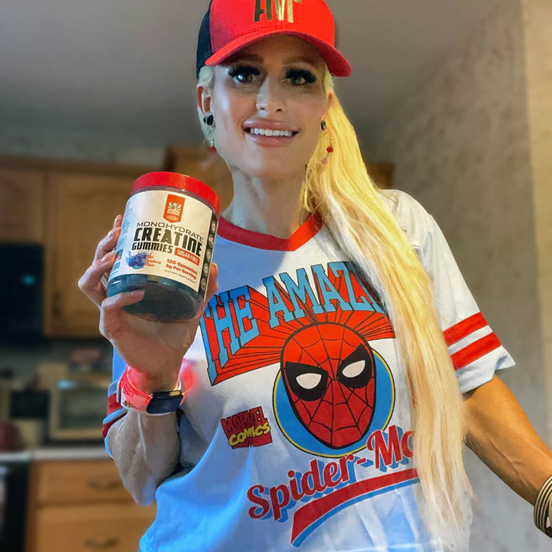 Woman wearing a Spider-Man shirt holding creatine gummies