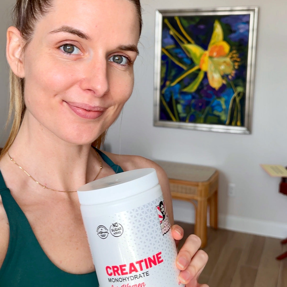 Woman holding bottle of creatine