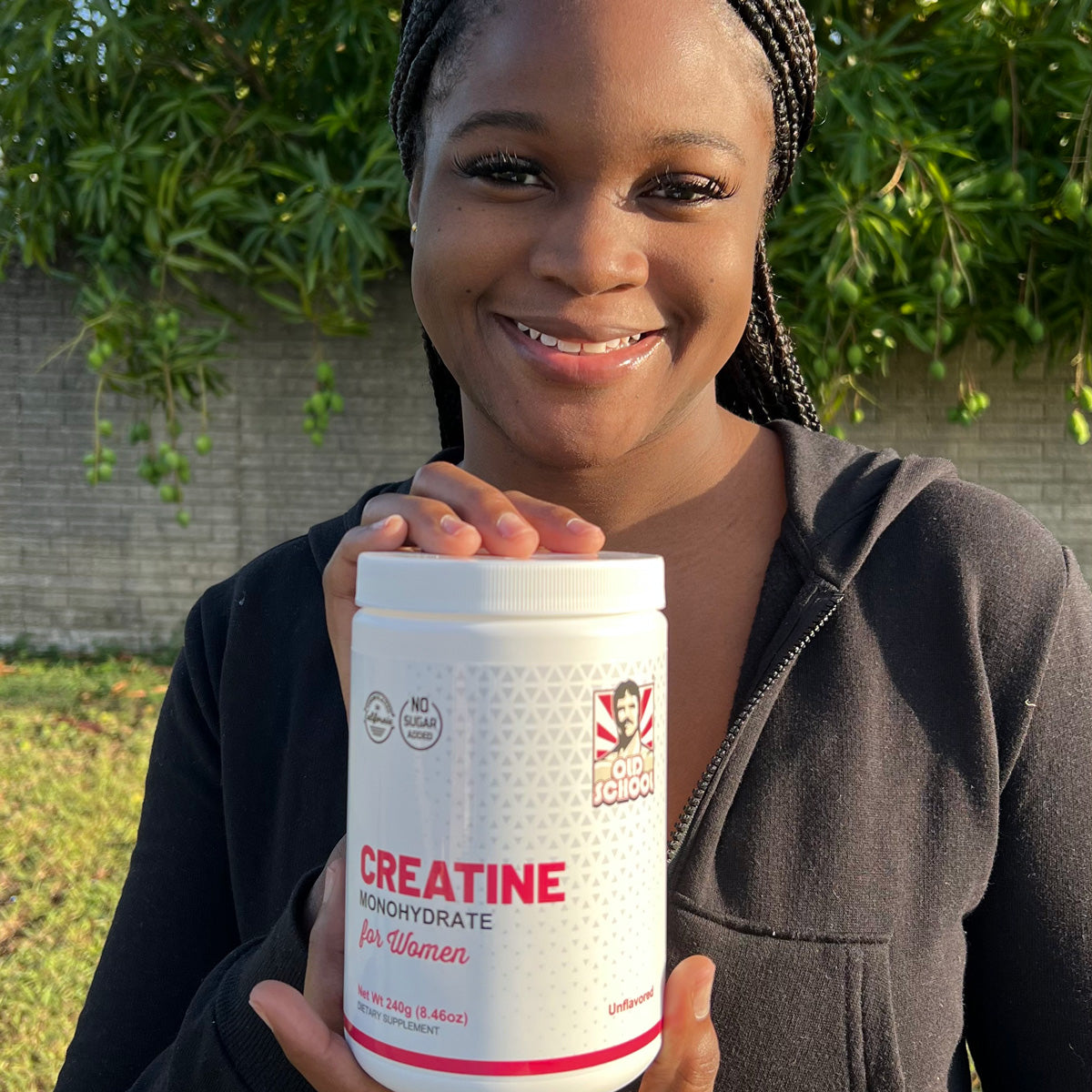 Woman holding bottle of creatine