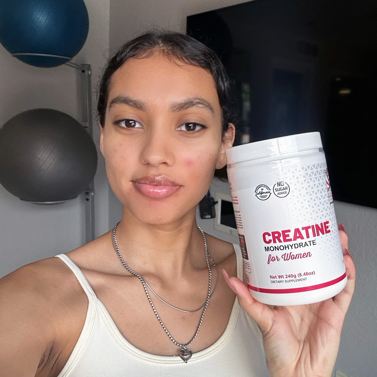 Woman holding bottle of creatine