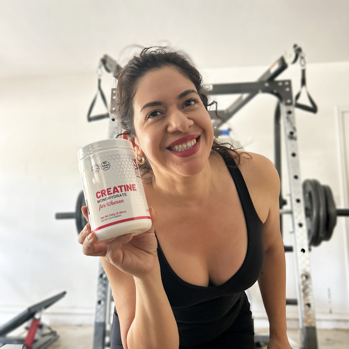 Woman holding bottle of creatine