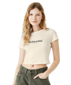 Woman wearing a beige crop top with 'Old School Labs' logo