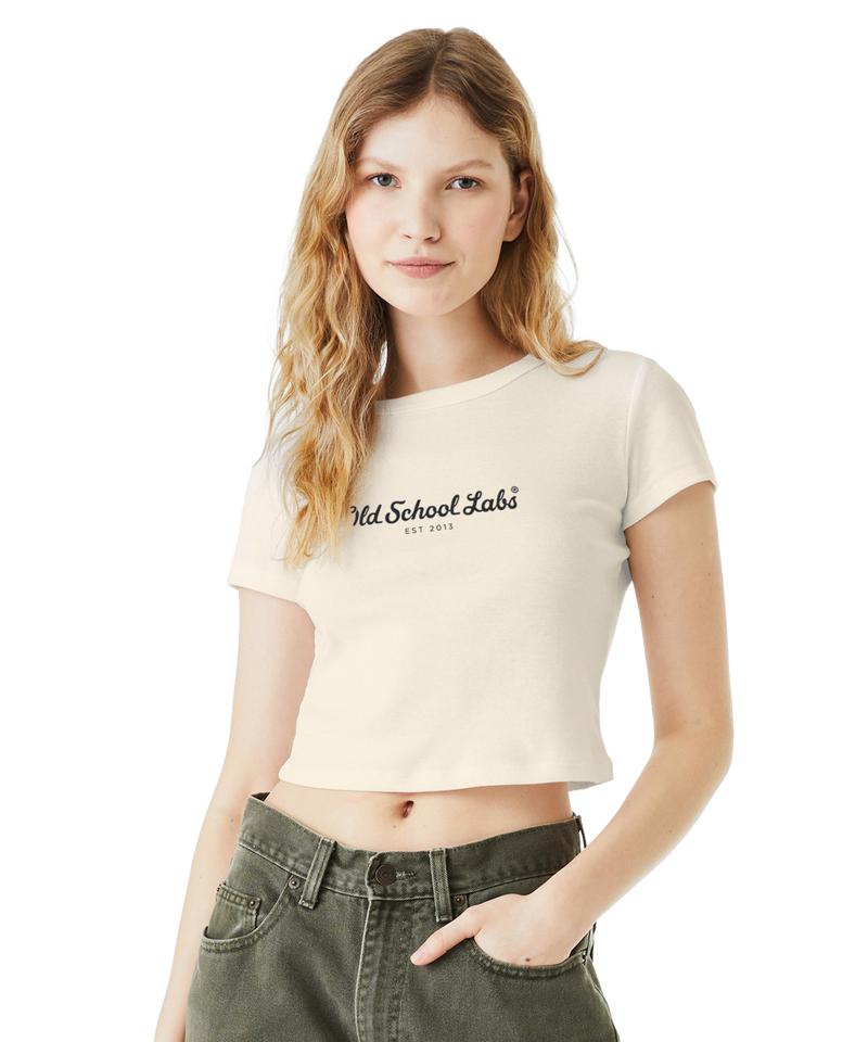 Woman wearing a beige crop top with 'Old School Labs' logo